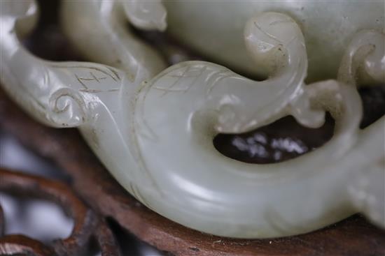 A Chinese archaistic pale celadon jade bi disc, 17th/18th century, Jade 8.3cm, frame 11cm x 12cm